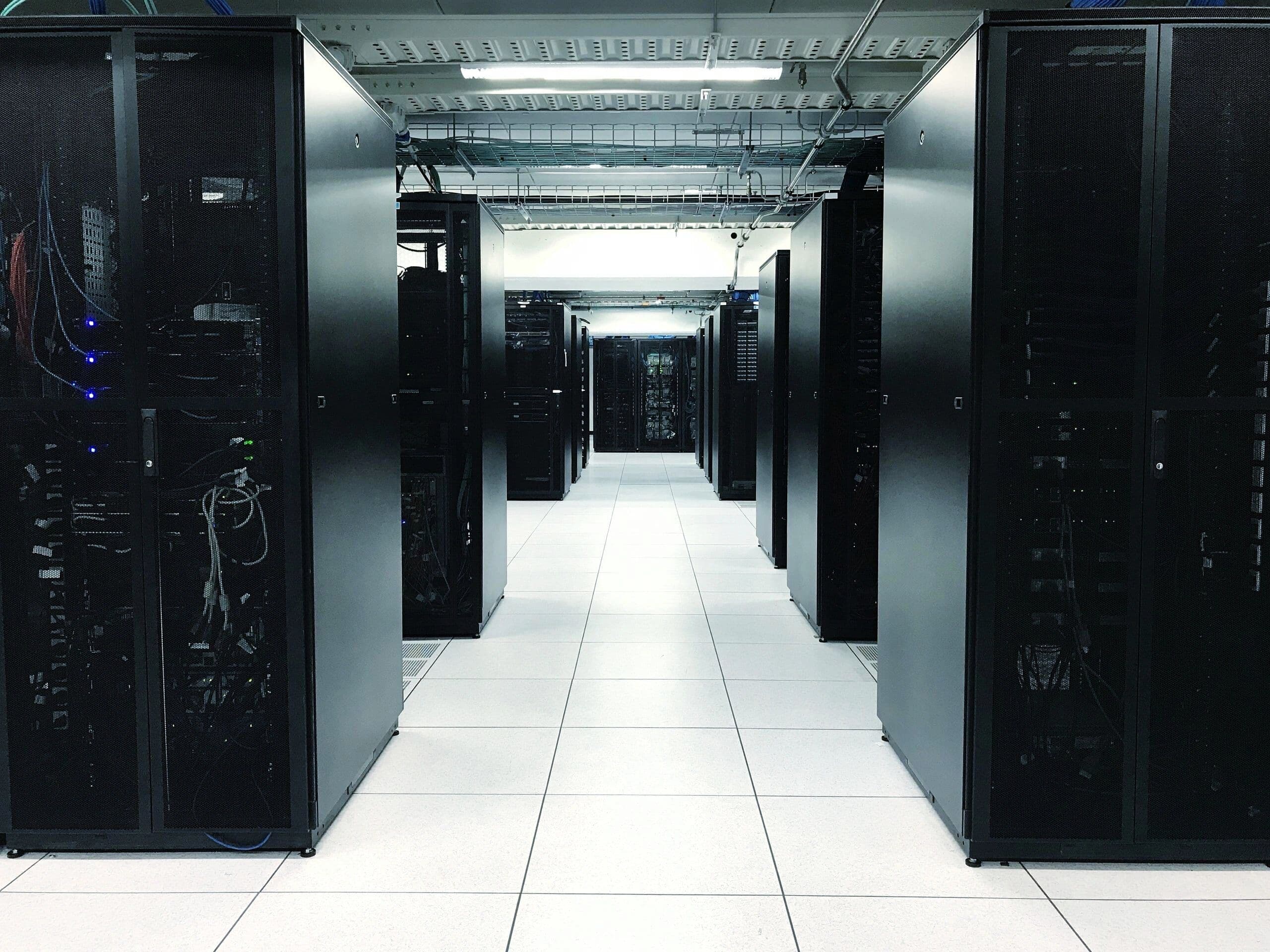 An aisle of server cabinets in a data hall